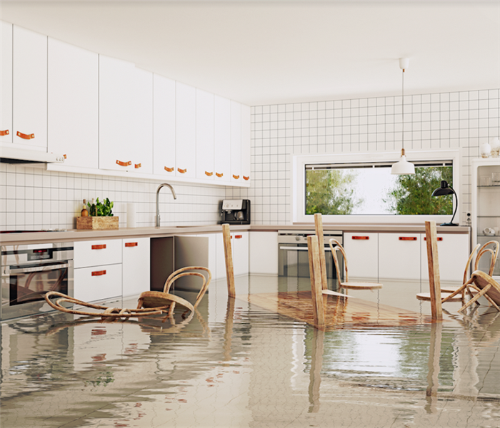 a flooded kitchen with water covering the floor